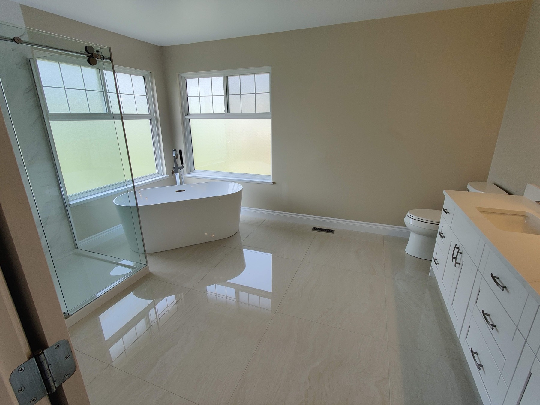 Bright bathroom with a freestanding tub and a long vanity