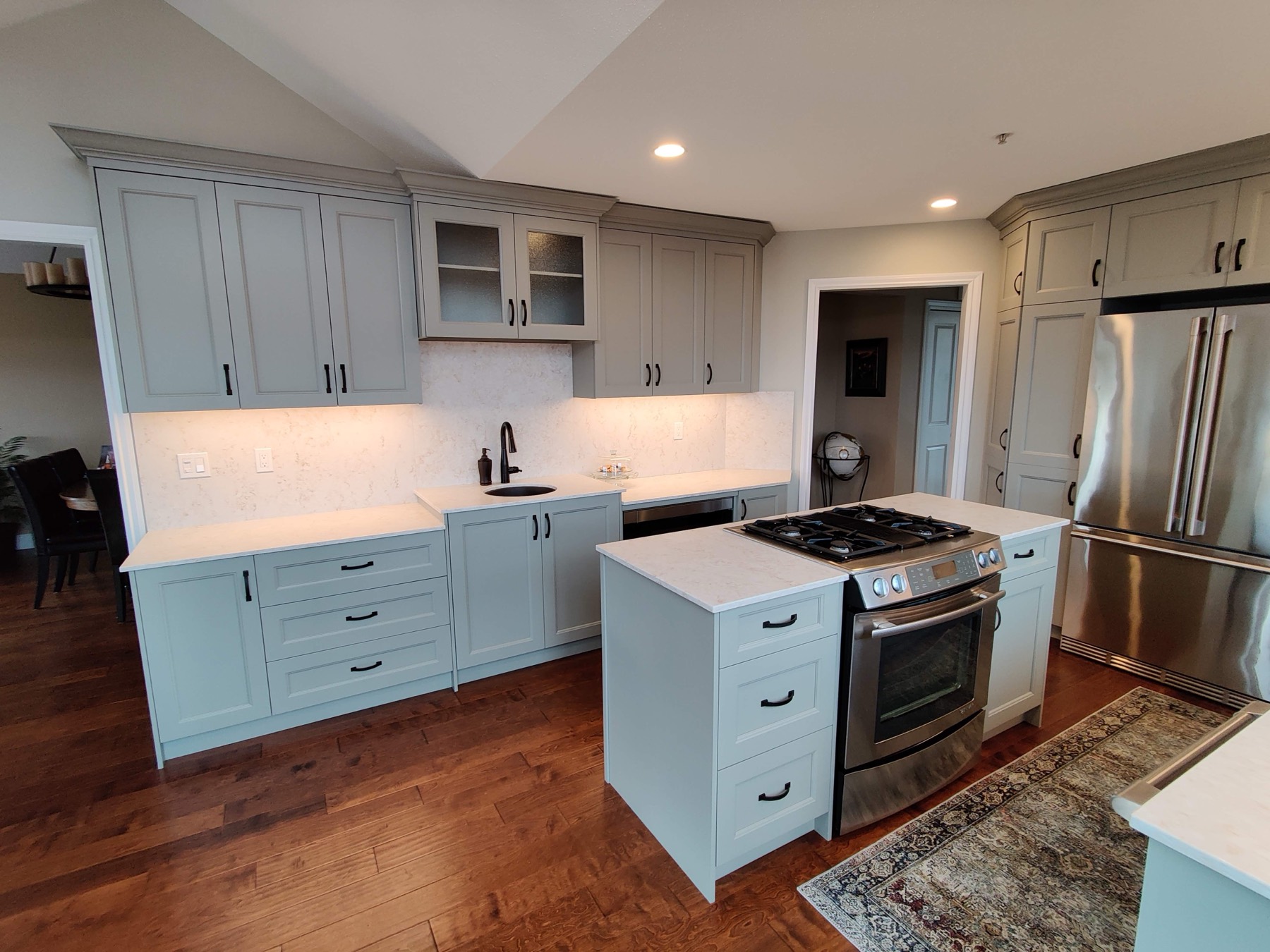Pale kitchen with an island and stainless appliances