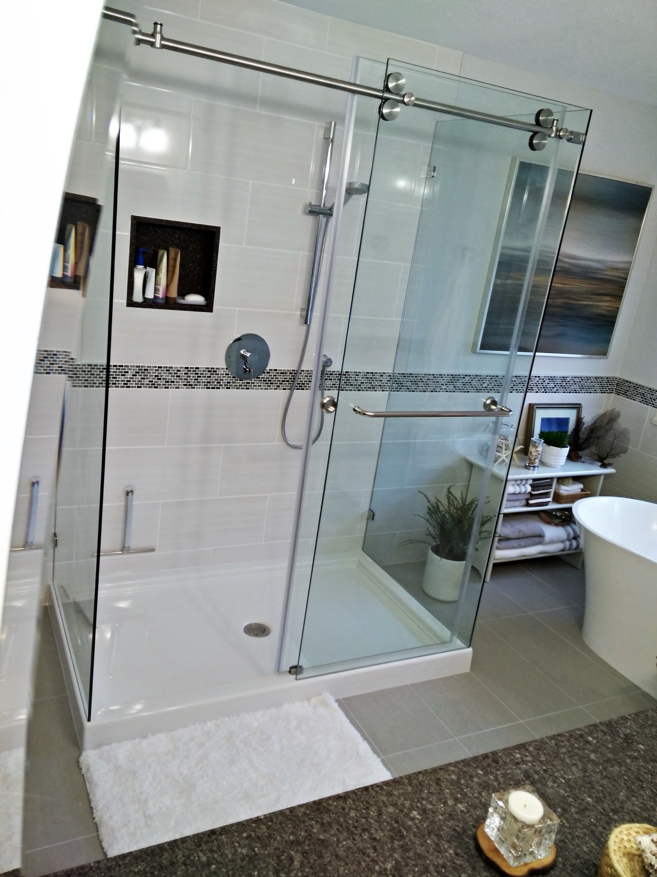 Sliding glass shower door on a tiled enclosure
