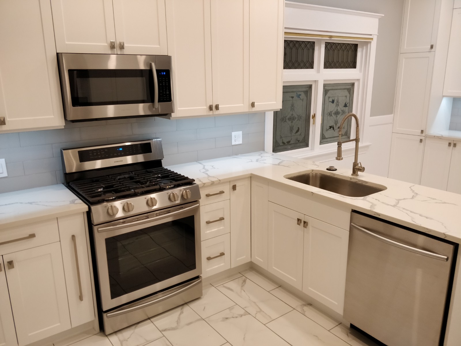 Kitchen with tiled backsplash and stainless range